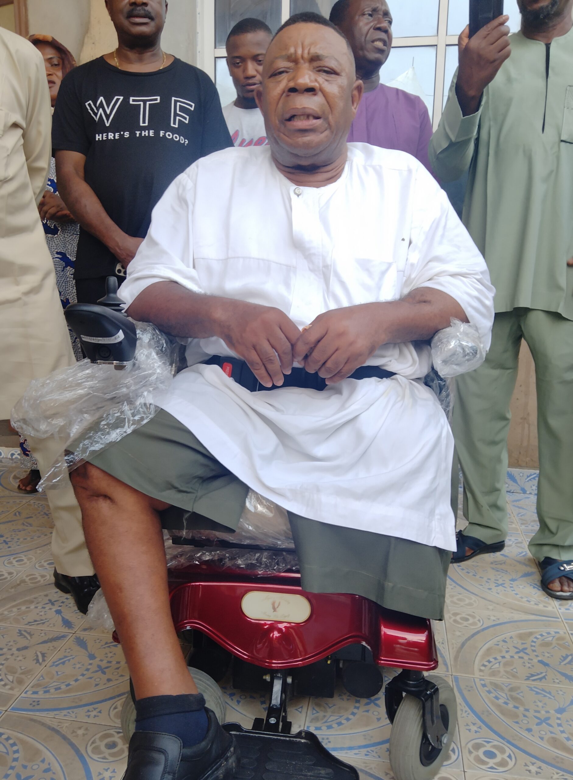Pomp As Prof  Emeghara Receives ‘Rosy Gift’ Of Motorized Wheel Chair From Old Girl ( VIDEO)